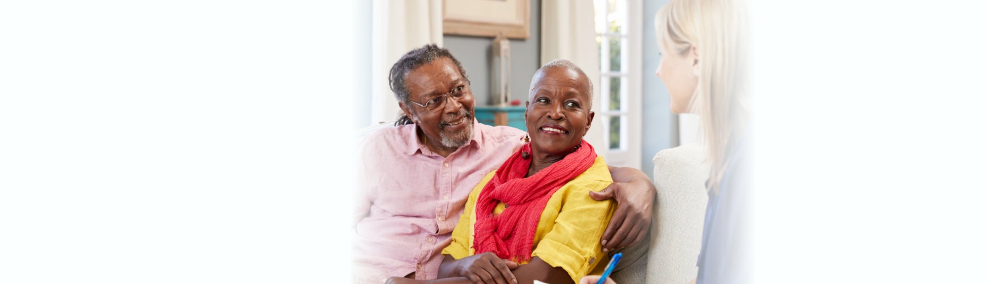 caregiver talking to elderly couple