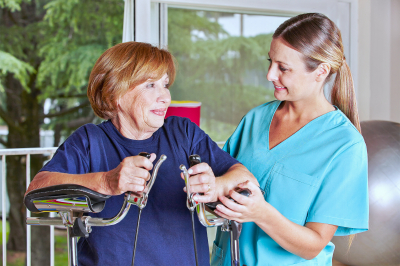 Nurse helping senior women in rehab in a physiotherapy