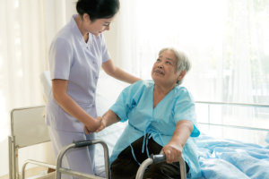 woman helping an elderly in the hospital